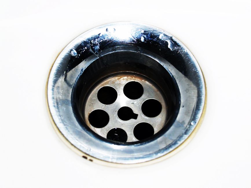 Close-up of a chrome sink drain, representing drain cleaning and clog removal services in Riverside, CA