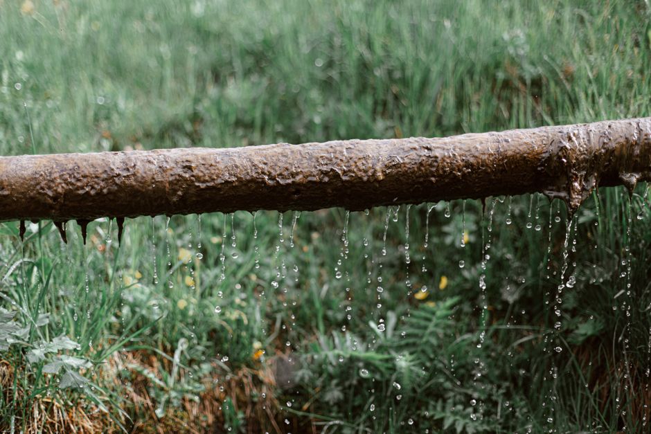 Rusted outdoor pipe dripping water, illustrating a hidden leak requiring professional leak detection services in Rancho Cucamonga CA