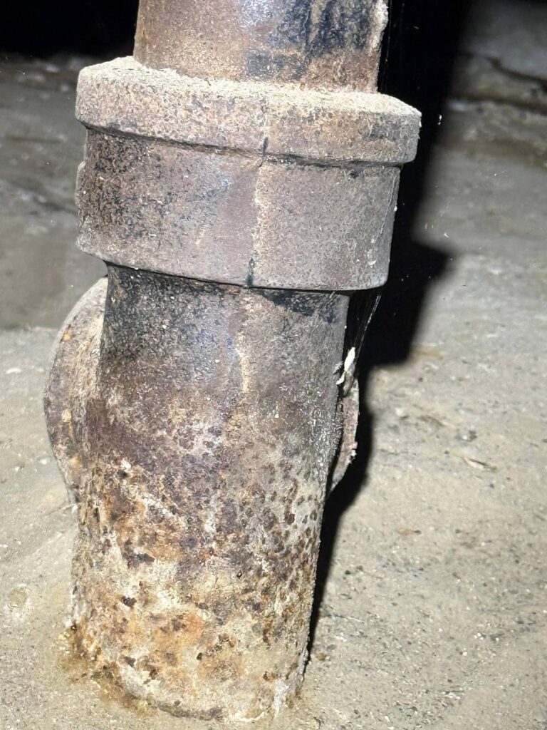 Corroded cast iron drain pipe found during a sewer inspection
