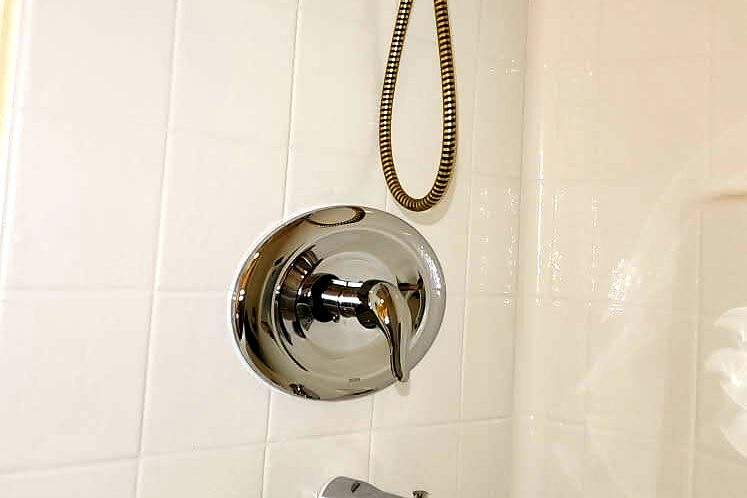 Completed tub and shower combo with new valve, spout and hand shower