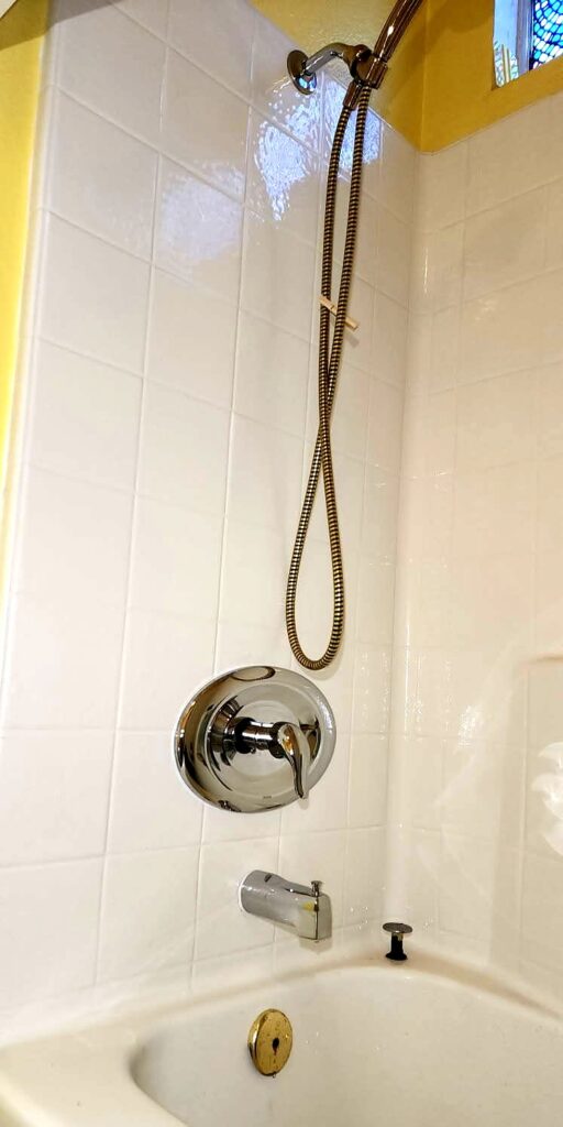 Completed tub and shower combo with new valve, spout and hand shower
