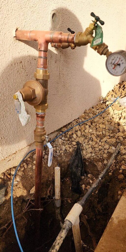 Copper water service line replacement with trench dug beside the home